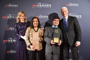 NEW YORK, NY - DECEMBER 11: (L-R) Kelly Ripa, CNN Superhero and 2012 CNN Hero of the Year Pushpa Basnet, 2016 CNN Hero of the Year Jeison Aristizaba of Asodisvalle, and Anderson Cooper poseduring the CNN Heroes Gala 2016 at the American Museum of Natural History on December 11, 2016 in New York City. 26362_013 (Photo by Michael Loccisano/Getty Images for Turner)